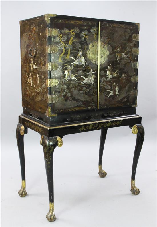 A late 17th century Chinese black lacquer cabinet, overall H. 5ft 3in.